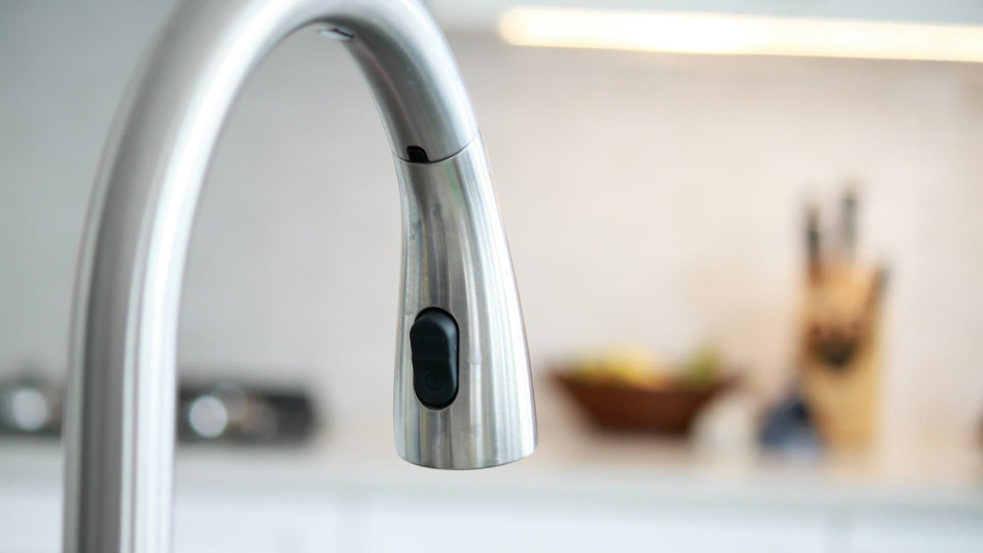 A polished stainless steel faucet in close-up